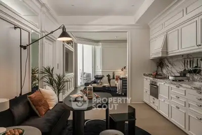 Luxurious open-layout kitchen and living room with elegant decor and modern appliances.