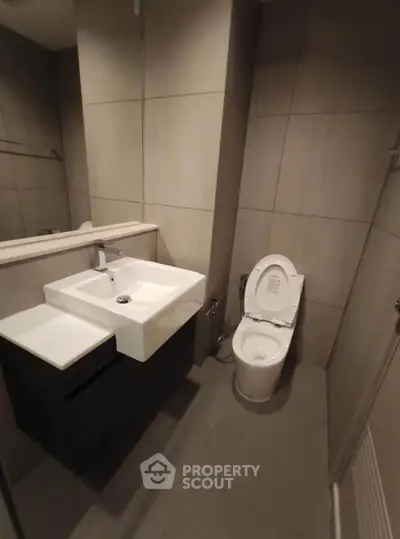 Modern bathroom with sleek design and contemporary fixtures in a real estate property.