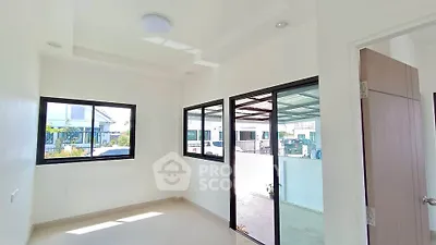 Bright and airy room with large windows and modern design, perfect for a cozy home office or study area.