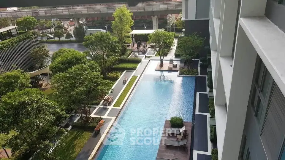 Luxurious residential pool area with lush greenery and modern design, perfect for relaxation and leisure.