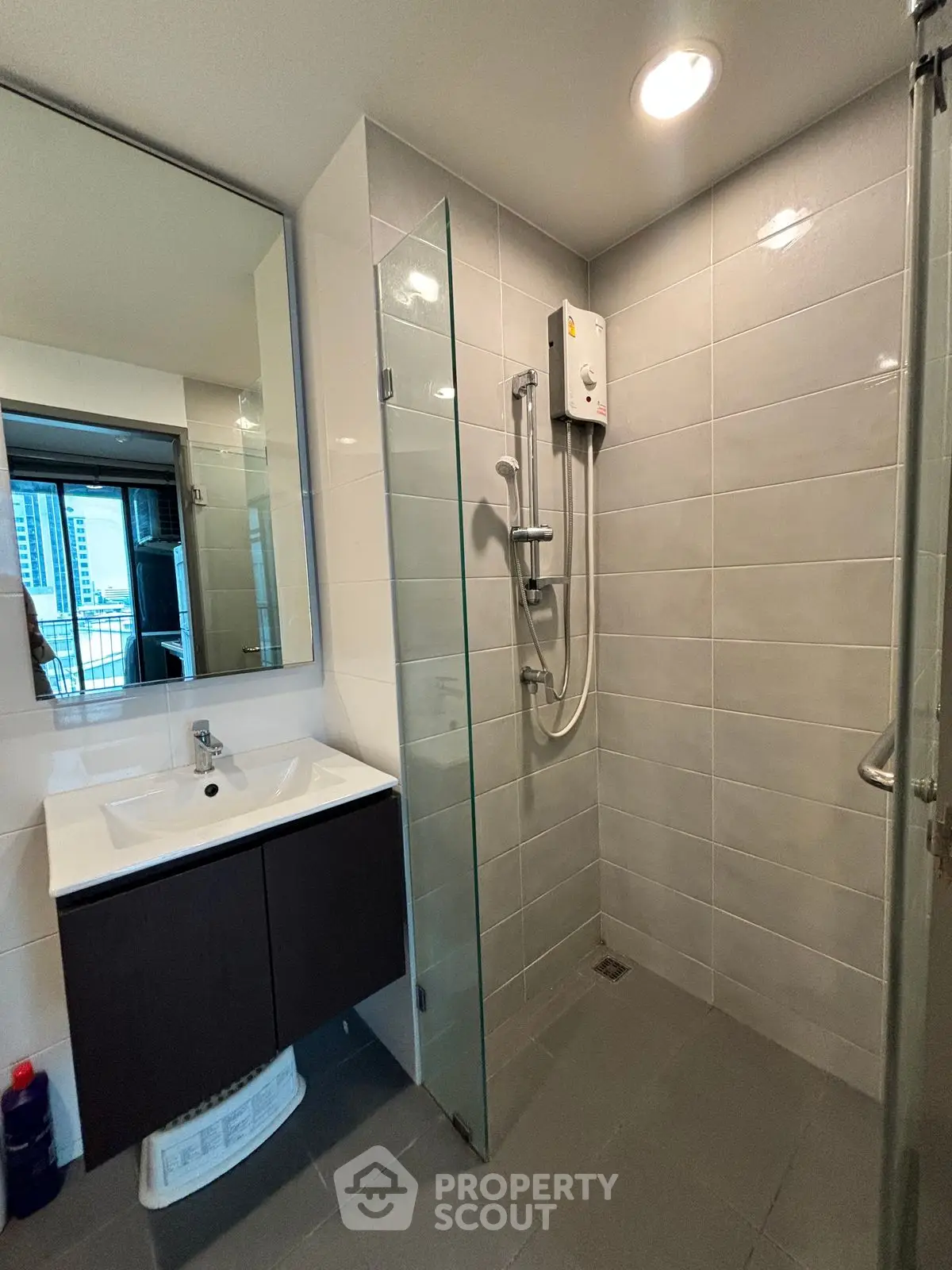 Modern bathroom with sleek shower and vanity in urban apartment