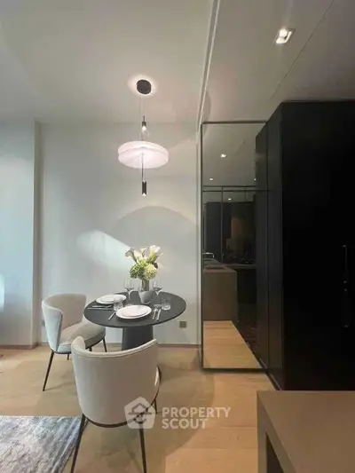 Elegant dining area with modern furniture and stylish lighting in a contemporary apartment.