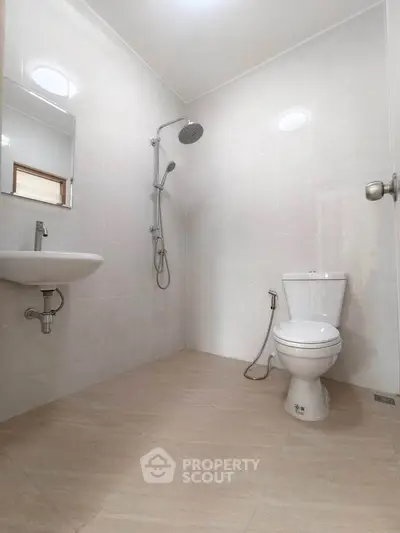 Modern minimalist bathroom with sleek fixtures and neutral tiles, perfect for a contemporary home.