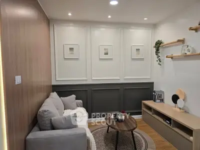 Chic modern living room with cozy sofa, stylish decor, and elegant wall paneling.