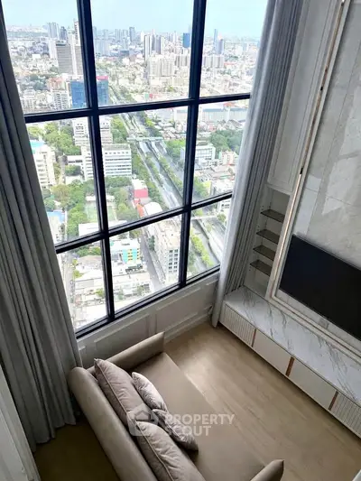 Luxurious high-rise living room with stunning city view through large windows, elegant decor and cozy seating.