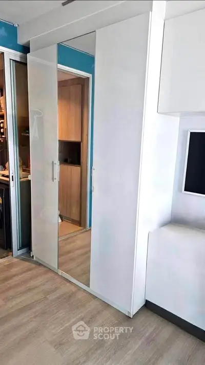 Modern interior with sleek wardrobe and wooden flooring in a stylish apartment.