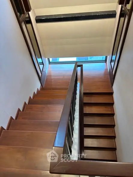 Elegant wooden staircase with modern design and natural light