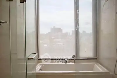Luxurious bathroom with city view and modern bathtub