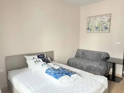 Cozy bedroom with modern decor and comfortable furnishings in a stylish apartment.