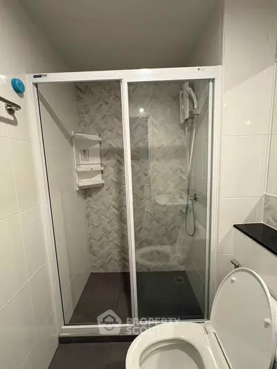 Modern bathroom with glass shower enclosure and sleek tile design