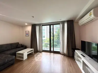 Spacious living room with modern decor and balcony view in a luxury apartment.