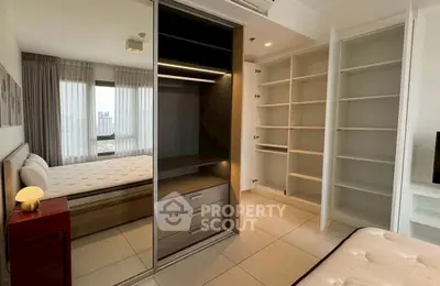 Spacious bedroom with built-in wardrobe and city view, ideal for modern living.