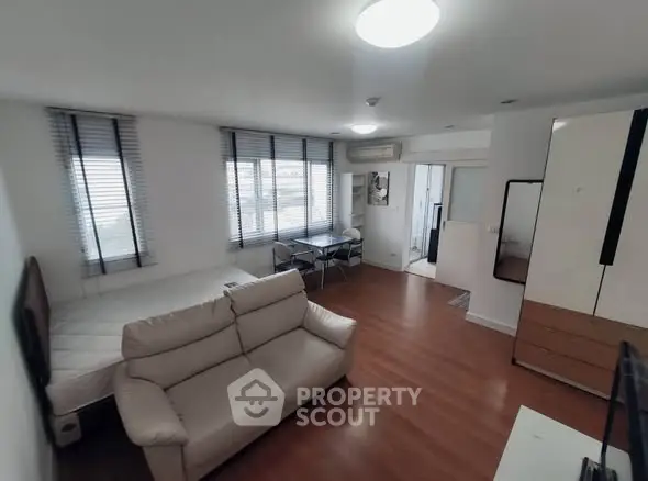 Modern living room with wooden flooring and stylish furniture in a bright apartment.