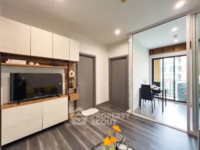 Modern living room with sleek TV unit and balcony view in stylish apartment