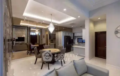 Luxurious open-plan living and dining area with elegant lighting and modern furnishings.