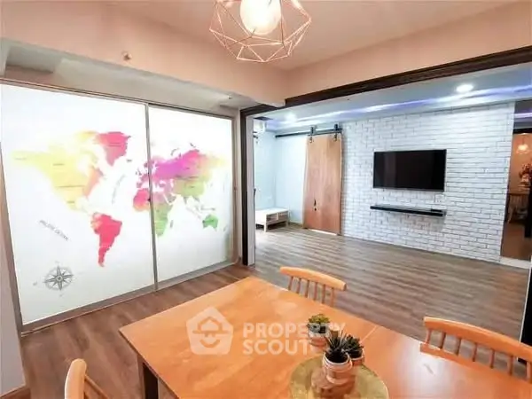 Stylish open living area with world map decor and modern TV setup