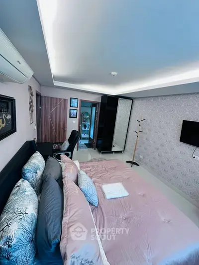 Spacious modern bedroom with stylish decor and ample natural light.