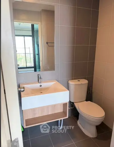 Modern bathroom with sleek sink and toilet in a stylish apartment.