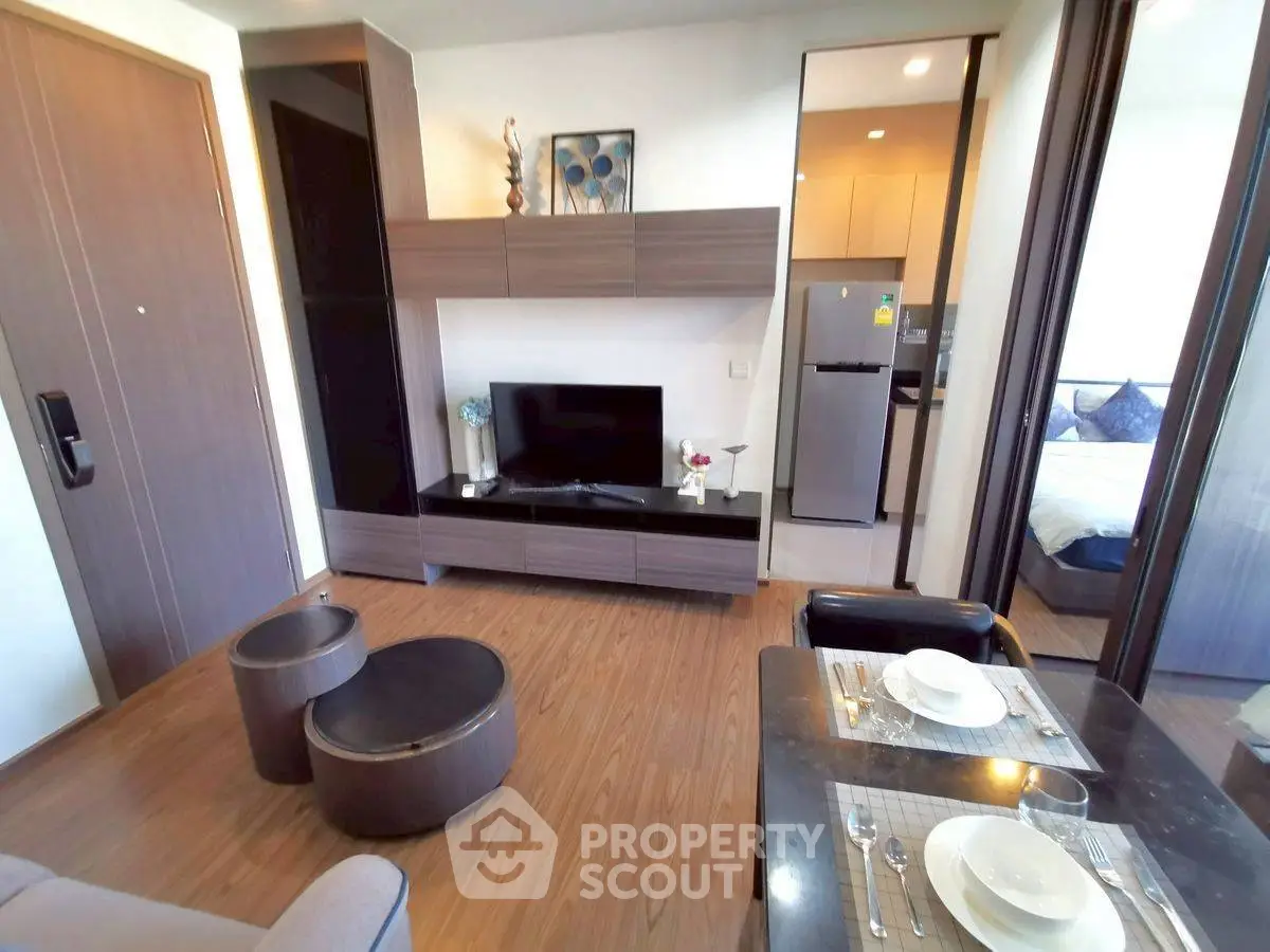 Modern living room with sleek furniture and open kitchen view