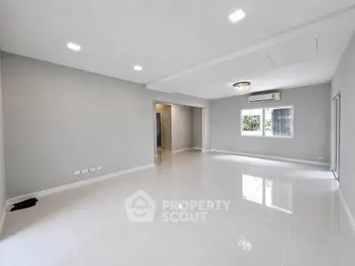 Spacious modern living room with glossy white tiles and elegant lighting