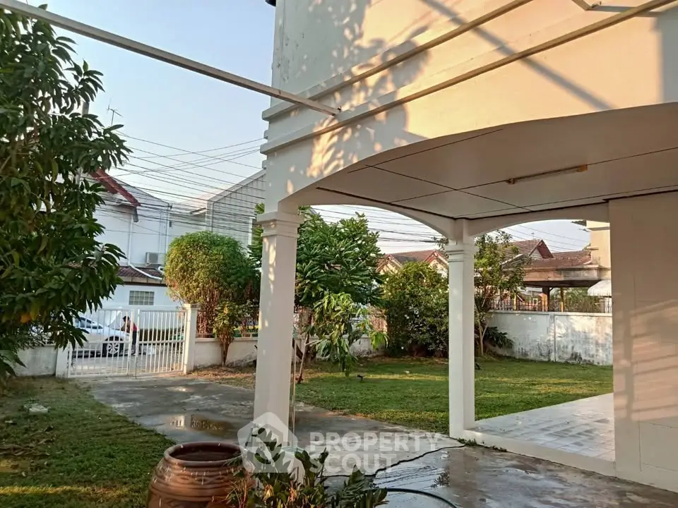 Charming suburban home with spacious garden and covered patio, perfect for outdoor relaxation.