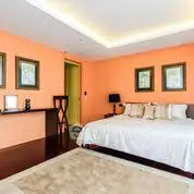 Spacious bedroom with elegant decor and warm lighting