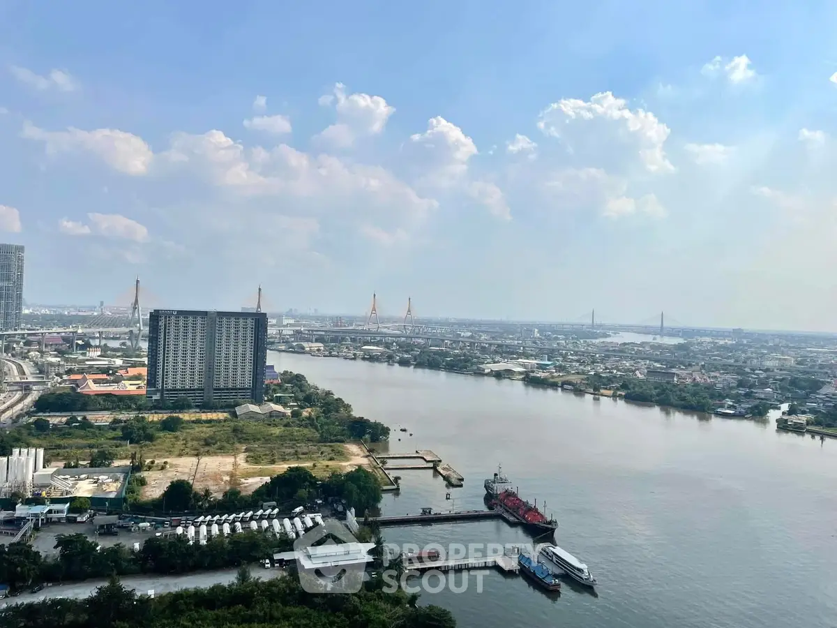 Stunning river view from high-rise building with cityscape and bridges in the background.