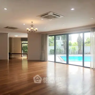 Spacious living room with pool view and elegant lighting