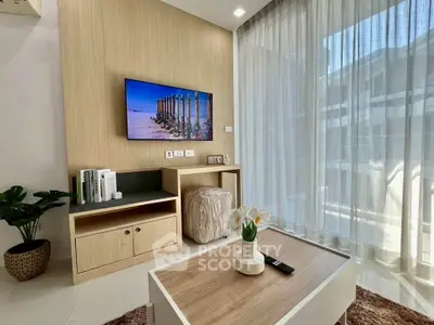 Modern living room with natural light, stylish decor, and a cozy ambiance.