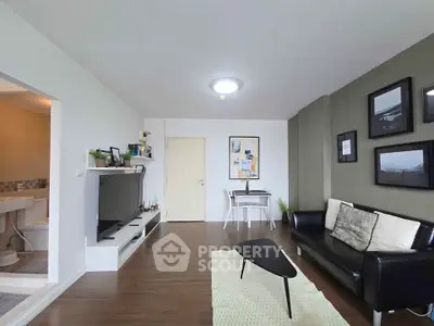 Modern living room with sleek furniture and stylish decor, featuring a cozy seating area and a wall-mounted TV.