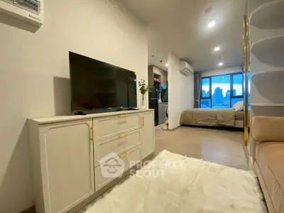 Modern apartment interior with cozy living room and bedroom, featuring stylish decor and city view.