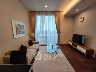 Elegant living room with modern decor and large window view