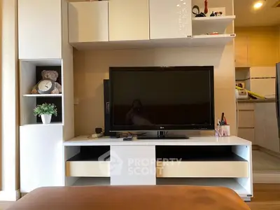 Modern living room with sleek TV unit and cozy decor, showcasing a stylish and inviting atmosphere.