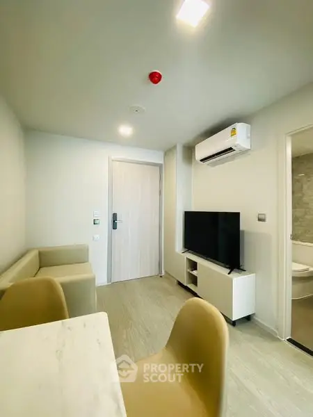 Modern living room with sleek furniture and wall-mounted TV