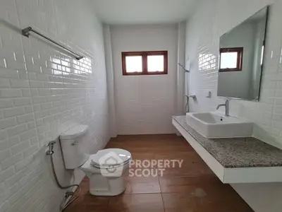 Modern bathroom with white brick tiles and wooden floor