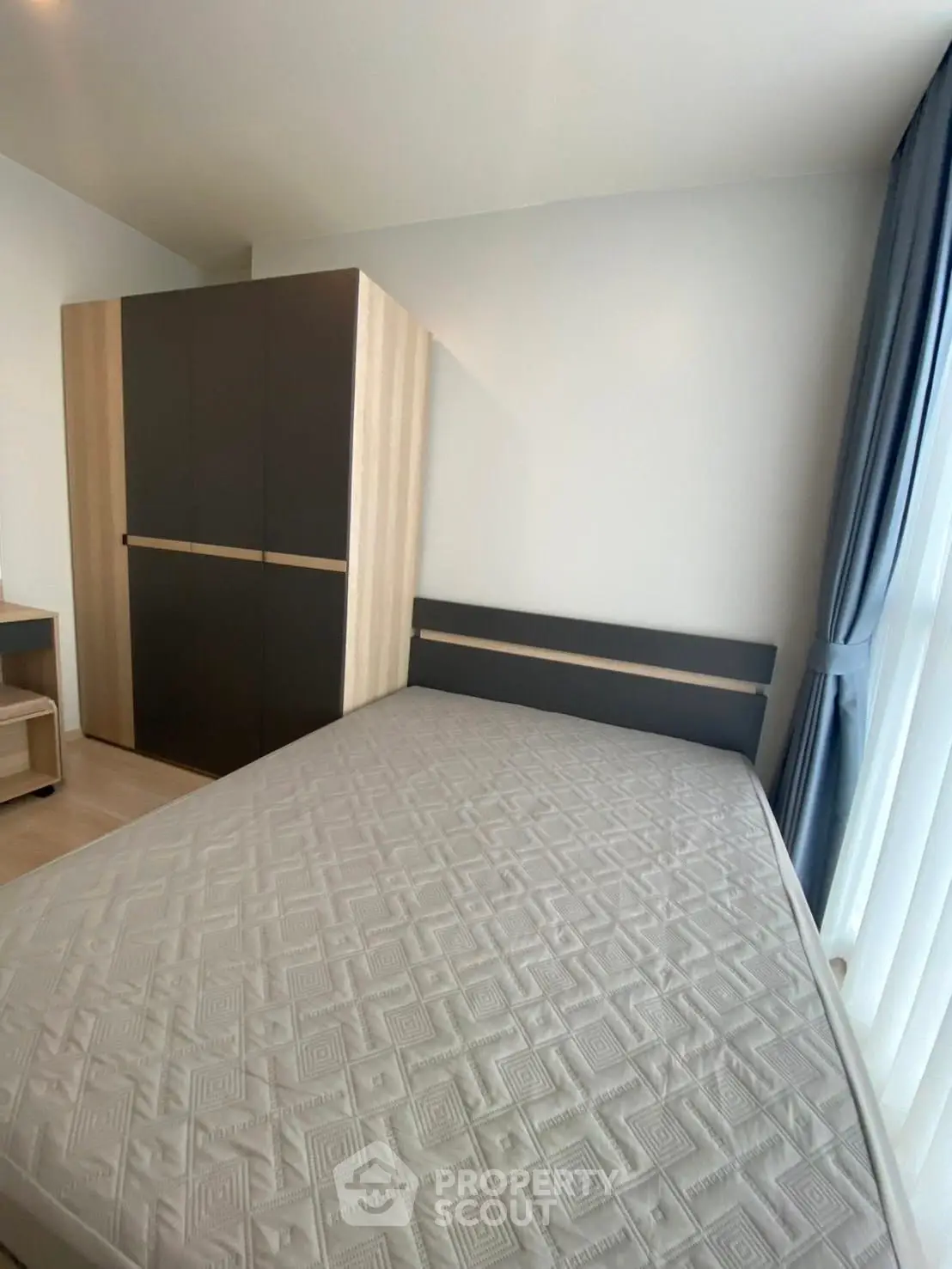 Modern bedroom with stylish wardrobe and large window