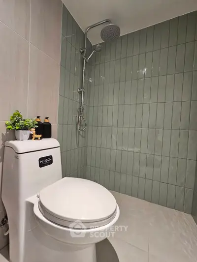 Modern bathroom with sleek shower and stylish green tiles