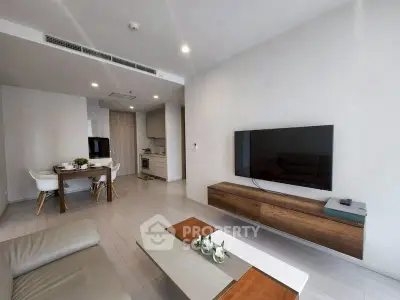 Modern living room with sleek furniture and open kitchen layout