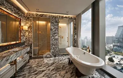 Luxurious marble bathroom with city view and freestanding bathtub
