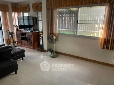 Spacious living room with natural light and modern furnishings