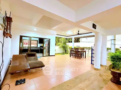 Spacious open-plan living area with garden view and modern furnishings