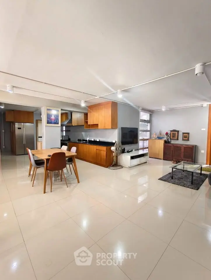 Spacious open-plan living and dining area with modern kitchen and stylish decor.