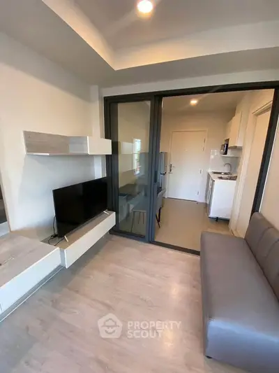 Modern living room with sleek furniture and open kitchen layout