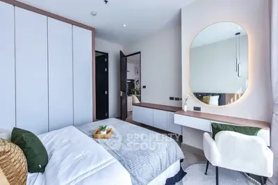 Modern bedroom with stylish decor and large mirror
