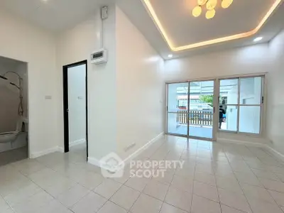Spacious modern living room with elegant lighting and large windows for natural light.