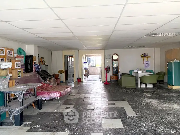 Spacious interior with potential for renovation, featuring tiled flooring and ample natural light.