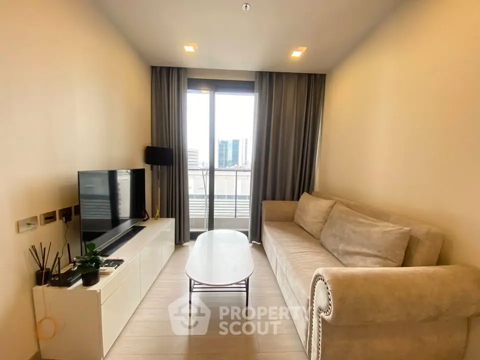 Cozy living room with modern decor and city view balcony access.