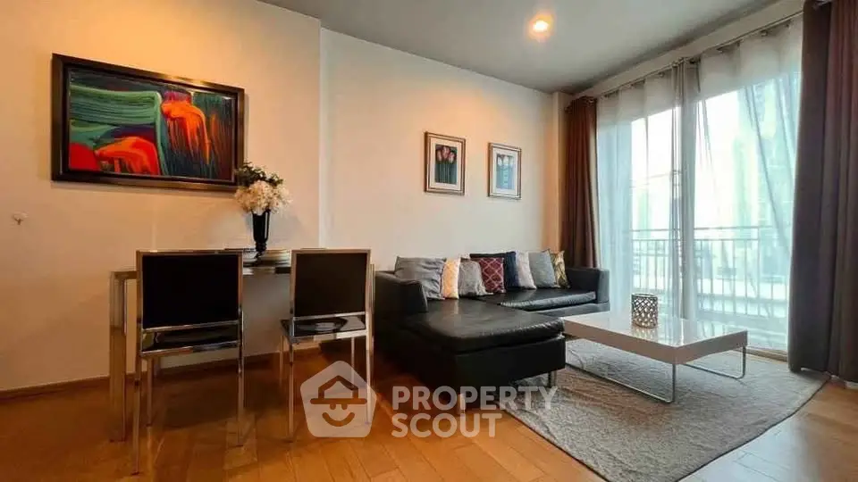 Modern living room with stylish decor and large windows offering natural light.