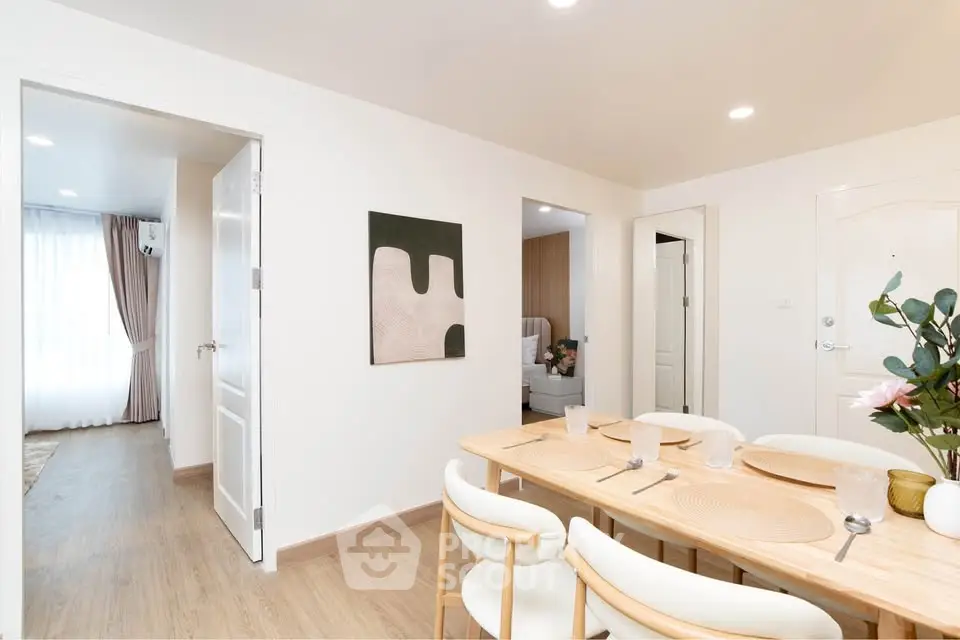 Modern dining area with elegant table setting and bright natural light