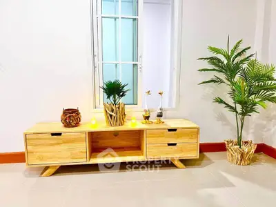 Stylish living room with modern wooden TV stand and decorative plants